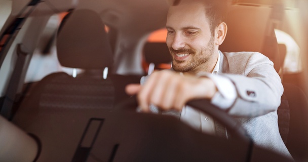 Man driving his new car