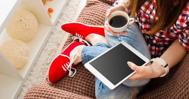 woman on ipad with cup of tea