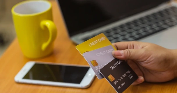 Close up of someone holding multiple credit cards