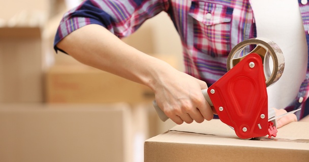 Person packaging moving boxes