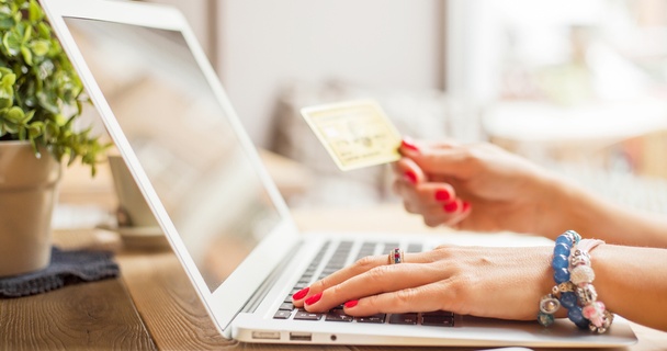 Shot of an open laptop with a womans hands on the keyboard