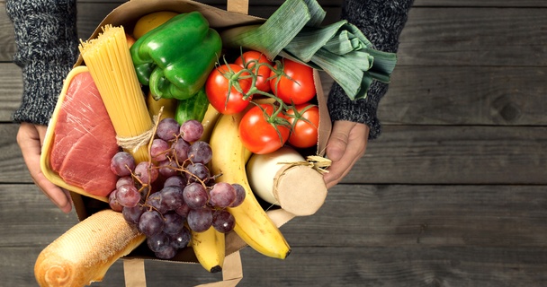 Bag of groceries including meat, pasta bread and vegetables