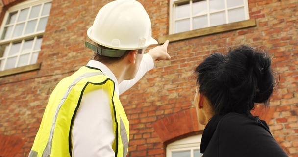 man surveying house