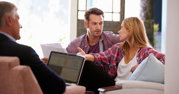 Couple speaking to a broker