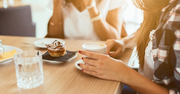 Friends drinking coffee and eating together