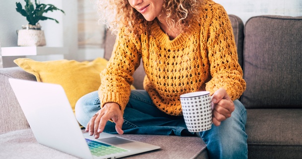 Woman on laptop drinking coffee