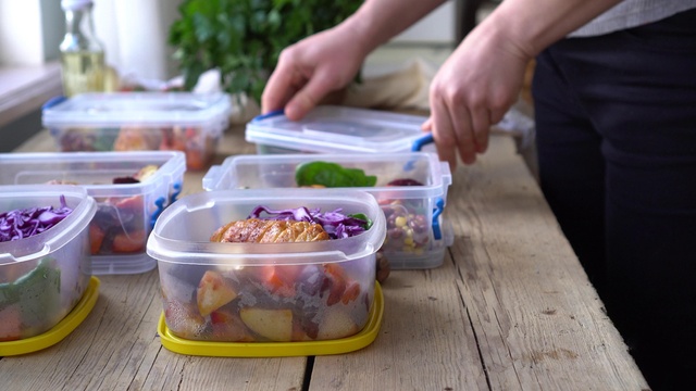 Man placing food prep into tupperware boxes