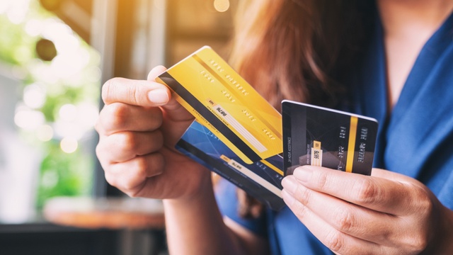 woman holding credit cards