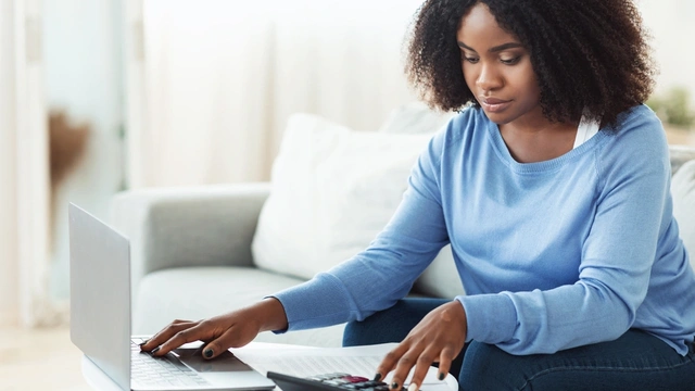 Woman doing finances at her laptop