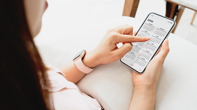 woman looking at the calendar on her phone