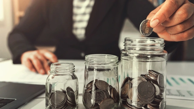 3 savings pots with coins in each one