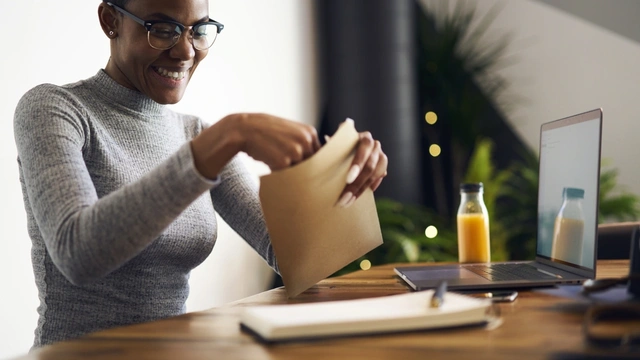 woman putting a letter into an envelope