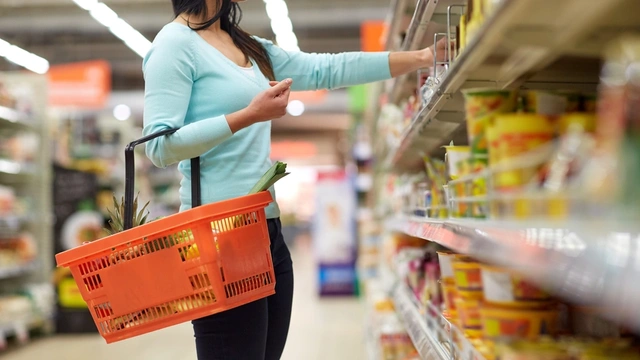 woman in supermarket holding a shopping basket