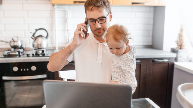 man on phone with small child