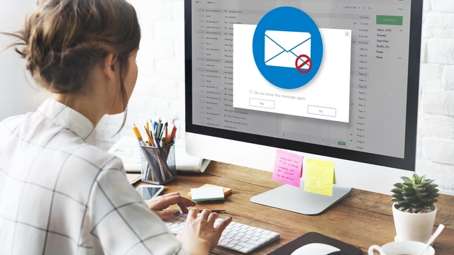 woman looking at her emails on her computer