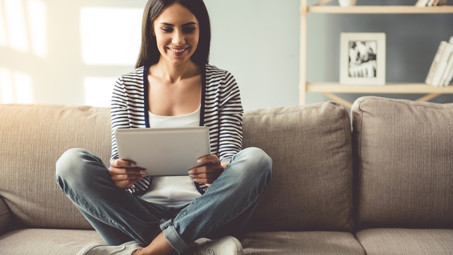 woman looking at tablet