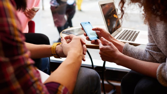 People looking at a mobile phone