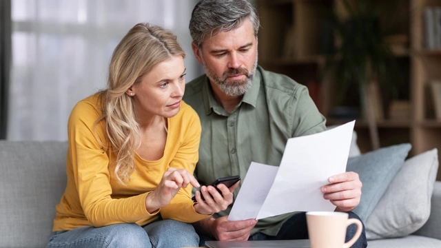 Couple looking at their finances at the dining table