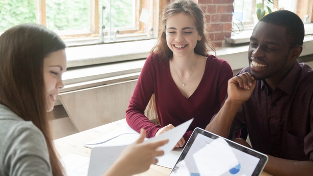 couple talking to a lender at a desk