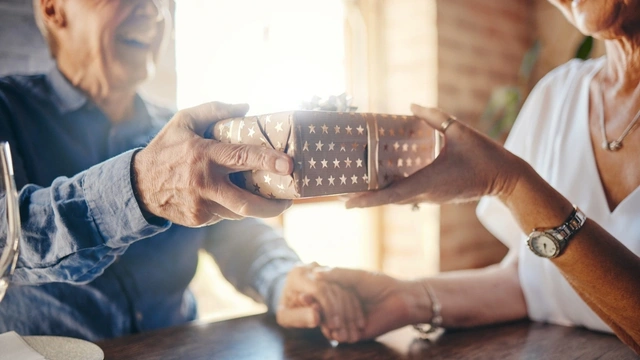 Senior couple exchange a gift