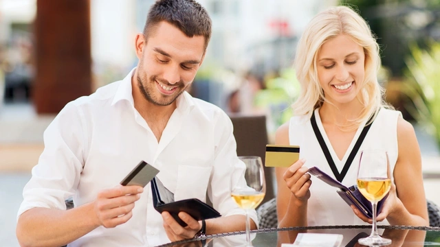 Man and woman looking at their bank cards