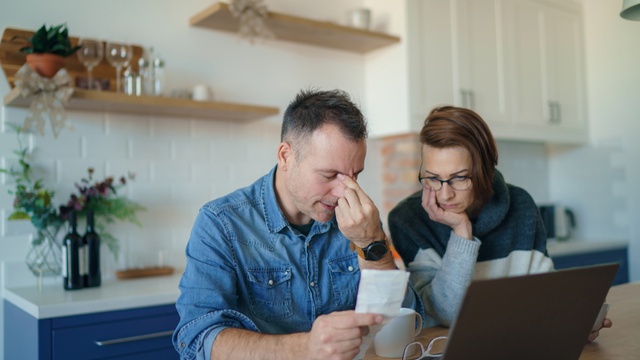 stressed couple looking at finances