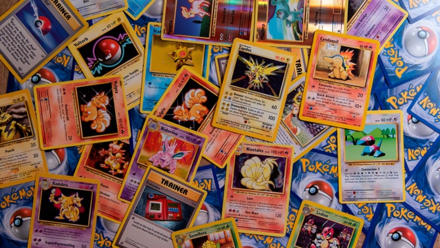 Hand holding rare Pokémon cards