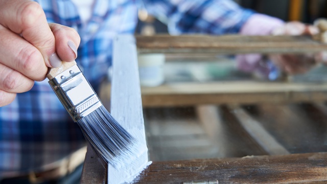 person painting wood