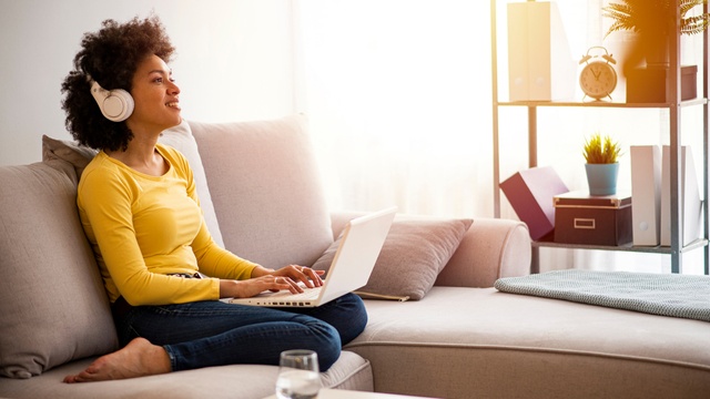 Woman on sofa with laptop