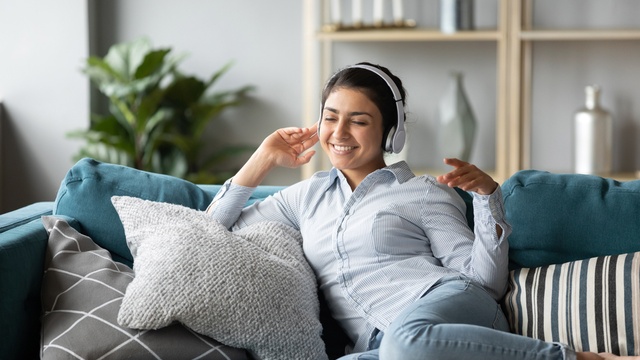 Woman on the couch with headphones on
