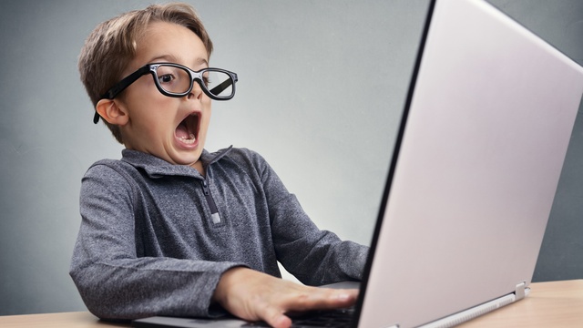 Person looking shocked at their computer