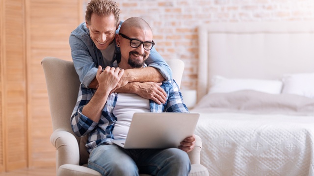 two men looking at laptop