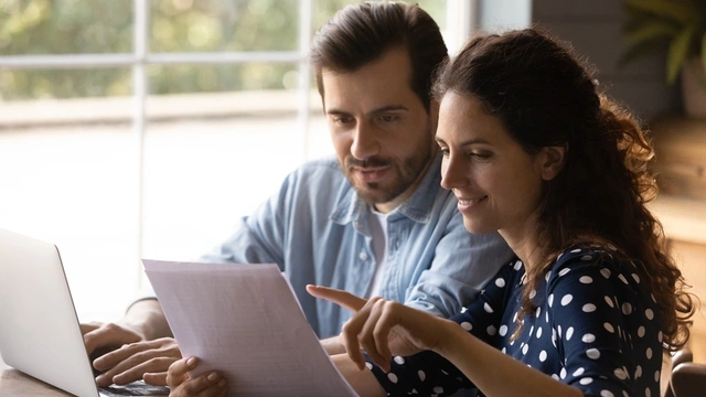 happy couple looking at paperwork together