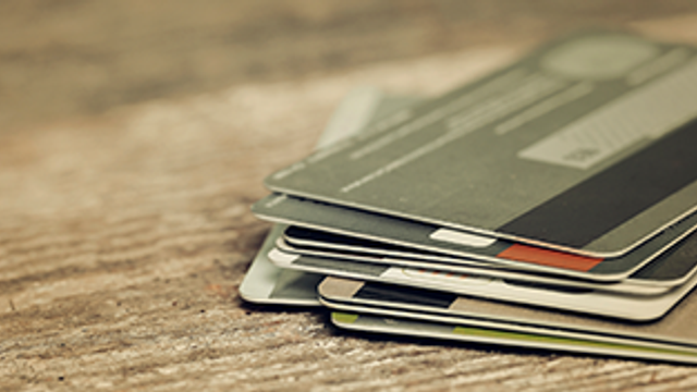 a stack of credit cards on a table
