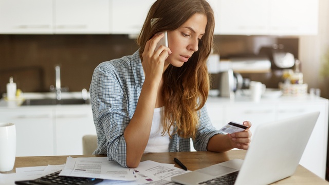 woman on phone with credit card