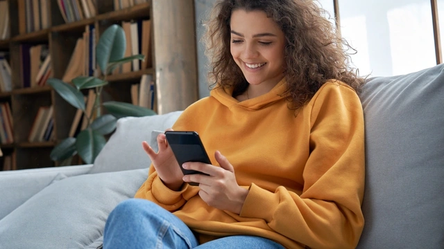 Woman smiling whilst looking at her mobile