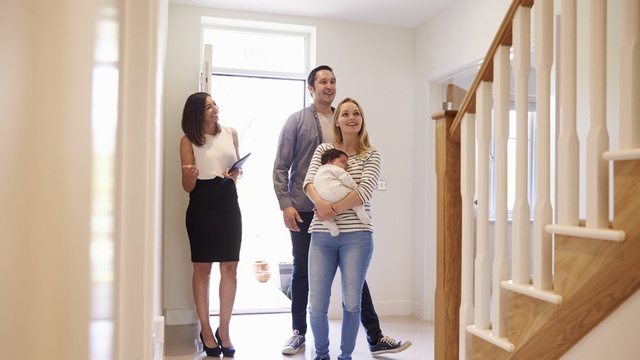 Young family being shown around a new home