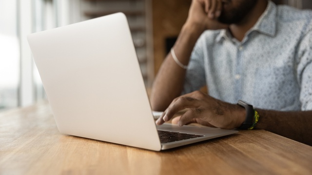 Man typing on a laptop