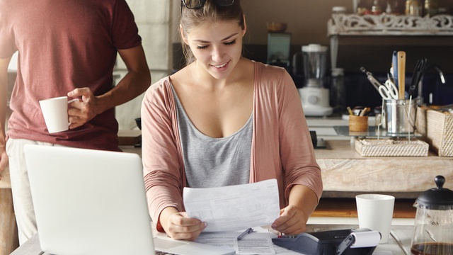Couple looking at documents in their kitchen