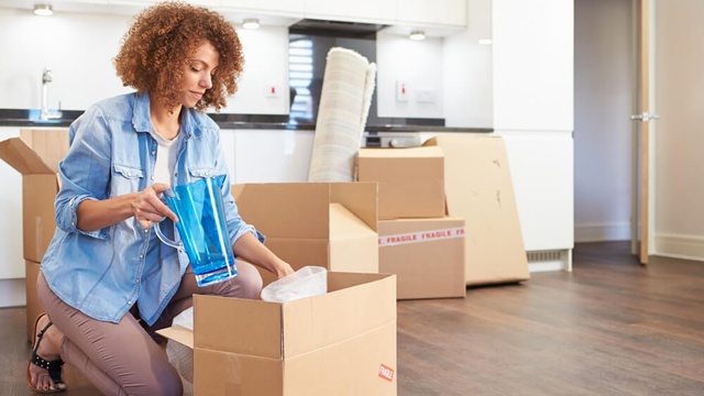 Person packing items away to move house