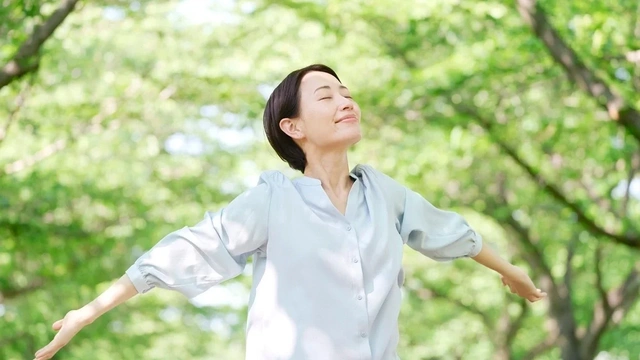 Woman in woods breathing