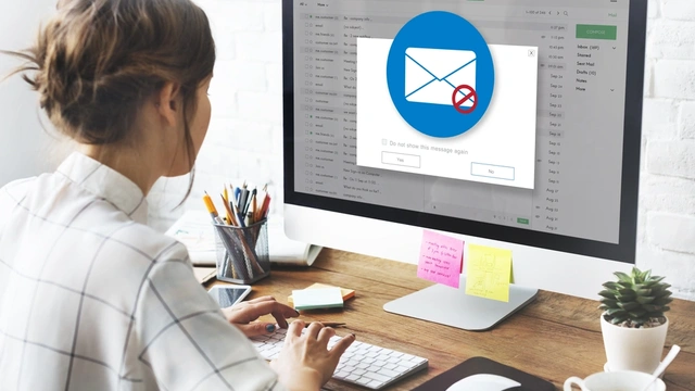 woman looking at her emails on her computer