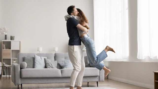 Couple celebrating in living room