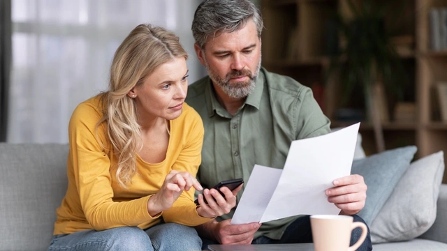 Couple looking at their finances at the dining table