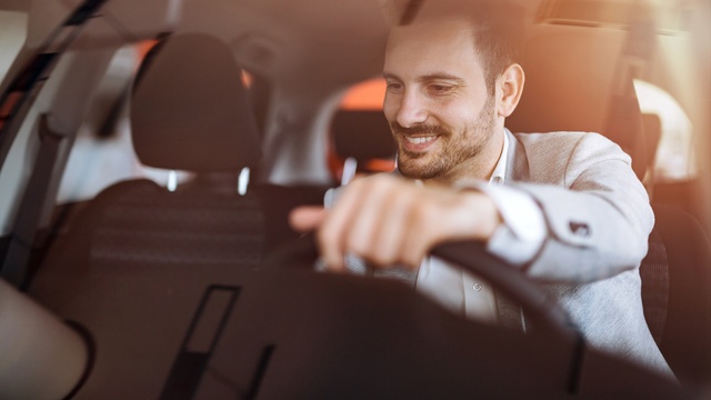Man driving his new car
