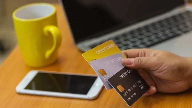 Close up of someone holding multiple credit cards