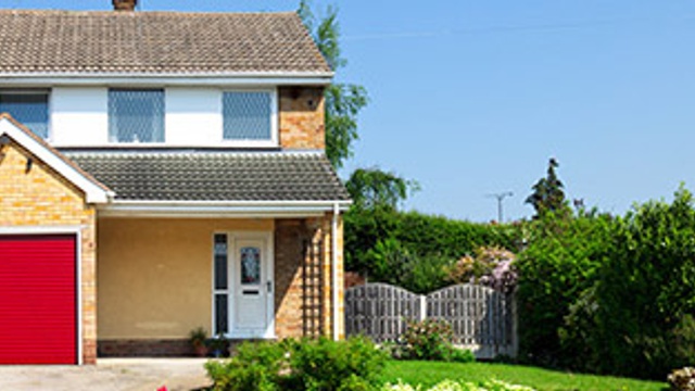 Image of a house with driveway and garden