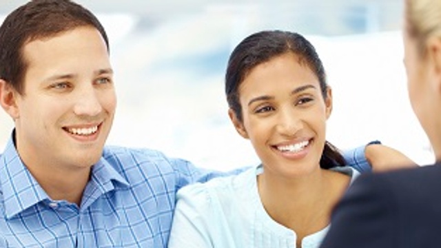 Couple talking to mortgage advisor