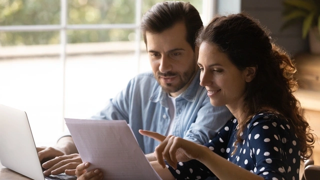 happy couple looking at paperwork together