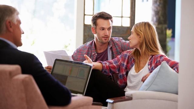 Couple speaking to a broker